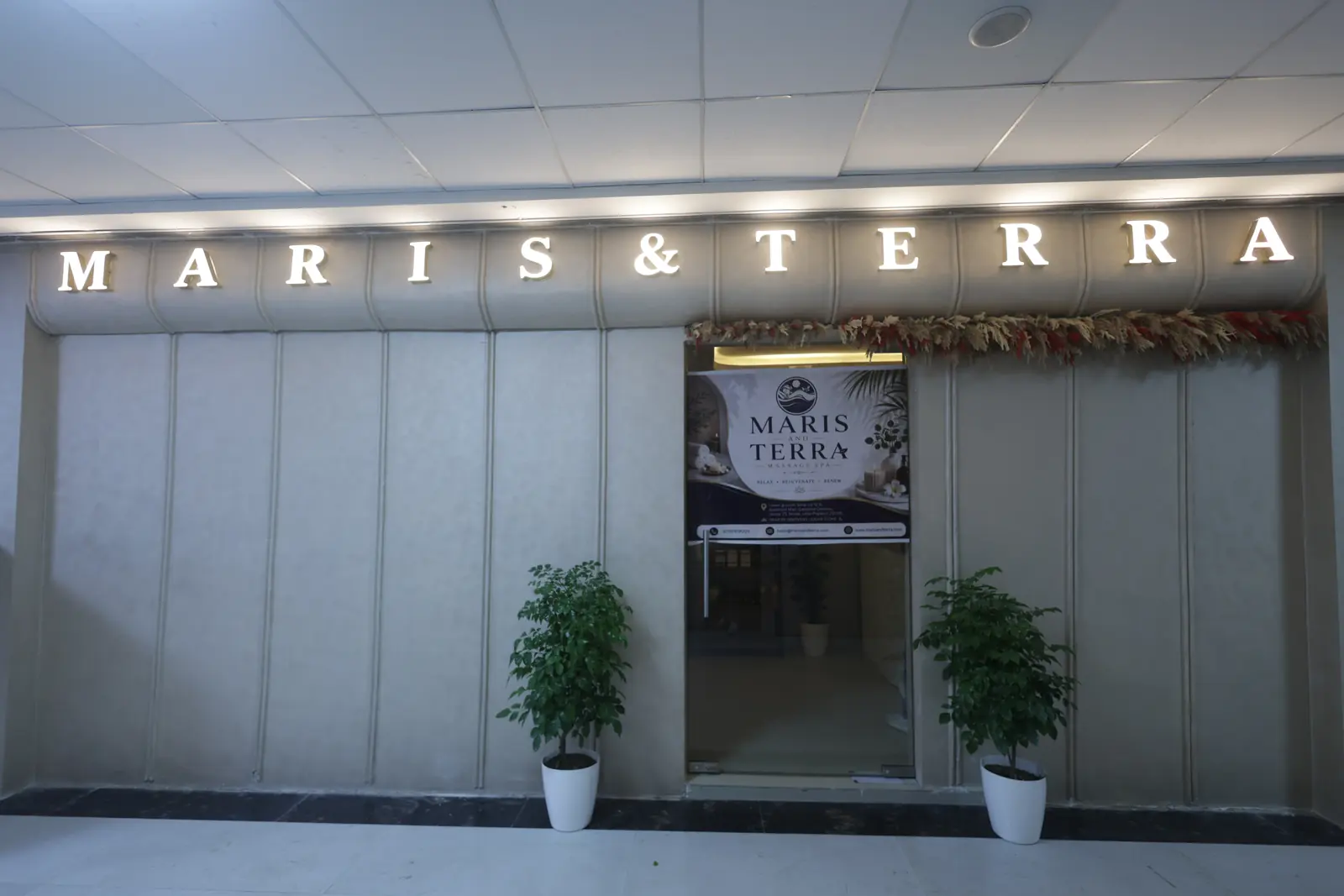 Backlit MARIS & TERRA signage across the spa frontage on the lower ground floor of Spectrum Mall, Noida