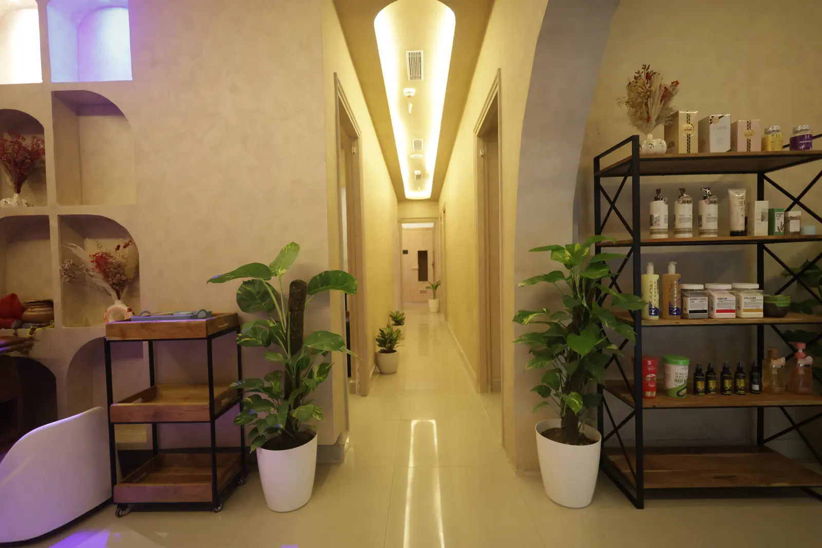 Warm cove-lit entry corridor immediately inside the Maris & Terra spa in Sector 75, Noida